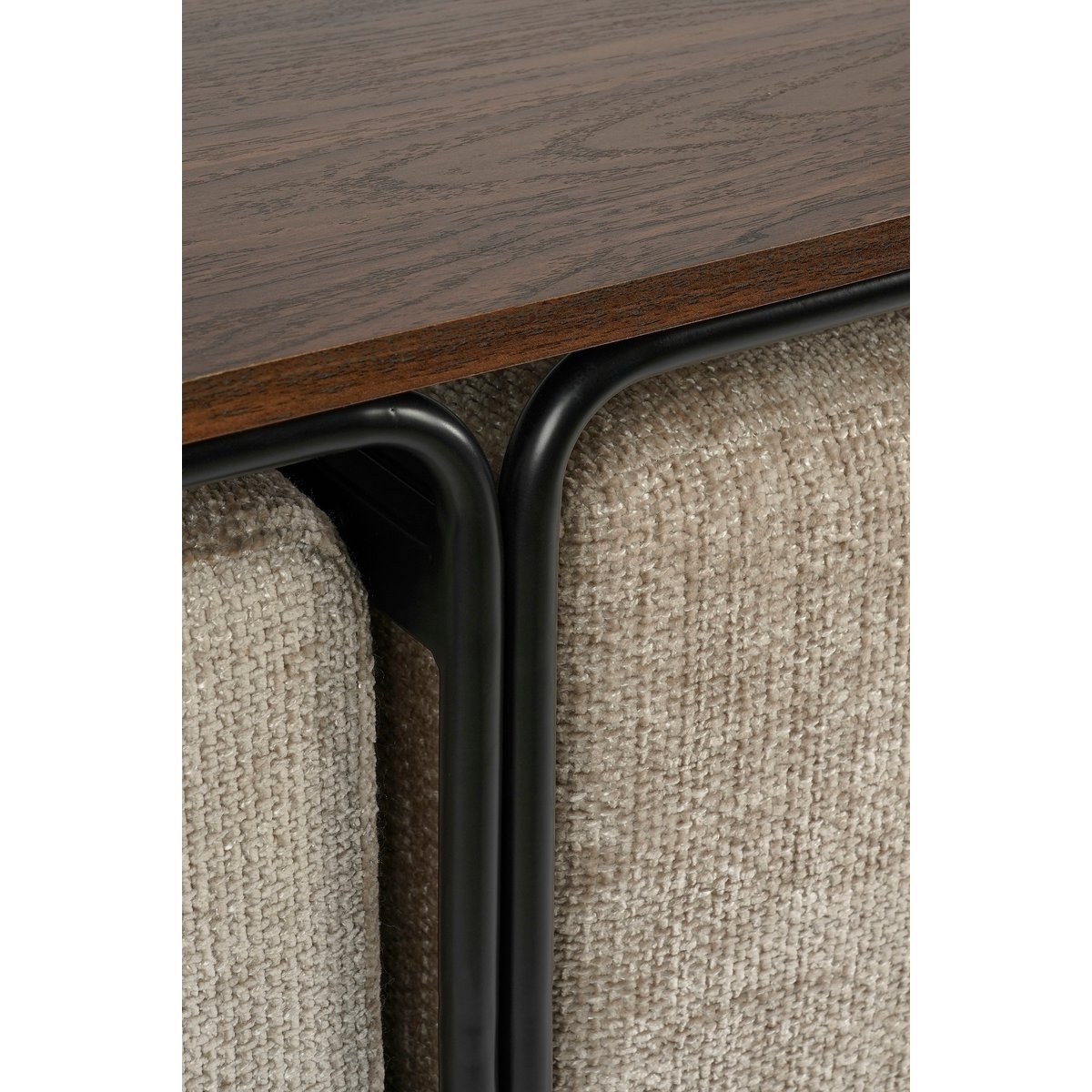 Closeup van een moderne salontafel met een ovale houten bovenkant en twee zachte beige poefs geïntegreerd in een zwart metalen frame. De poefs kunnen los worden gebruikt als extra zitplaatsen of voetenbankjes. Een stijlvolle en multifunctionele toevoeging aan elk eigentijds interieur.