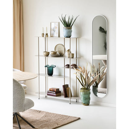 Groene glazen vaas gestyled in kast met accessoires
