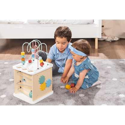Twee kinderen spelen met houten activiteitenkubus van Pinolino – kleurrijk, leerzaam speelgoed voor peuters.