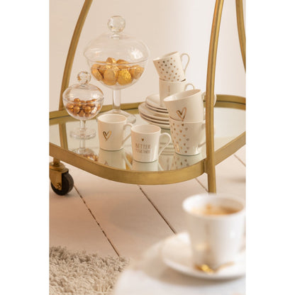 J-Line trolley driehoekig goud en wit gestyled met theeset, bar cart in woonkamer interieur
