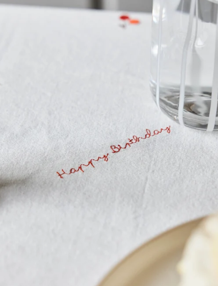 Katoenen verjaardagstafelkleed wit 260x140 cm, detail van het geborduurde "happy birthday" erop