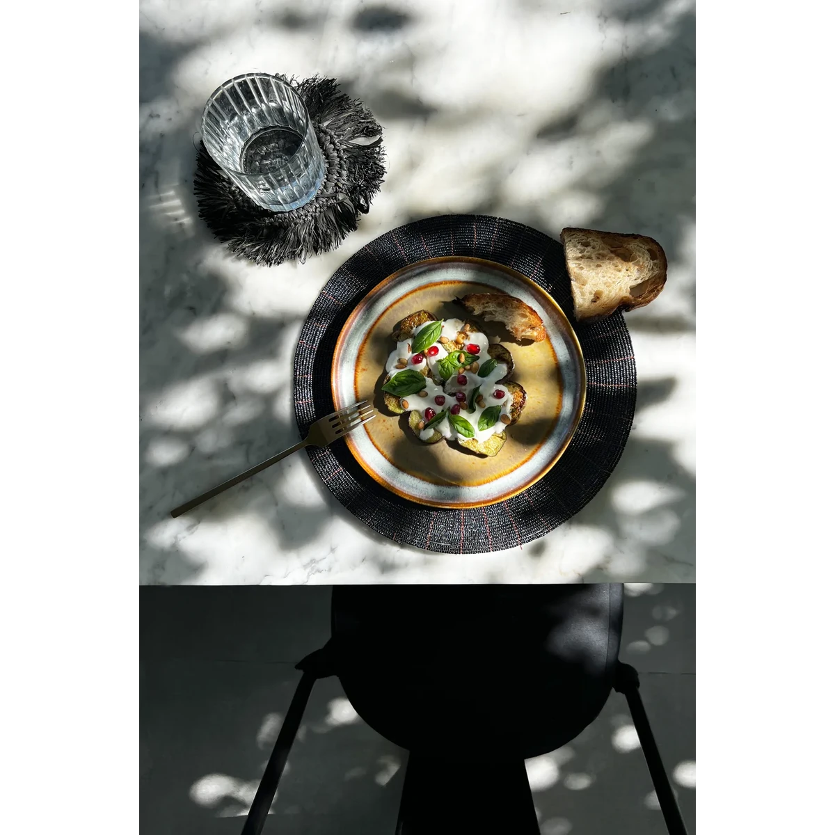 Kralen placemat zwart 30 cm met daarop een bord met lekker eten van bovenaf