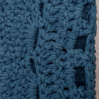 Rond vloerkleed blauw Alma van katoen, ingezoomed op het detail van het haakwerk en patroon