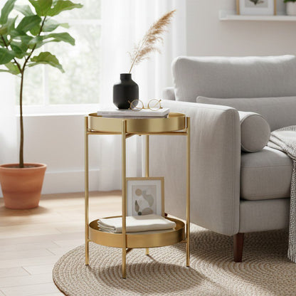Ronde bijzettafel goud metaal met opbergruimte 32 cm in een zacht interieur met decoratie zoals een pot met plant, handdoeken en schilderijen erop