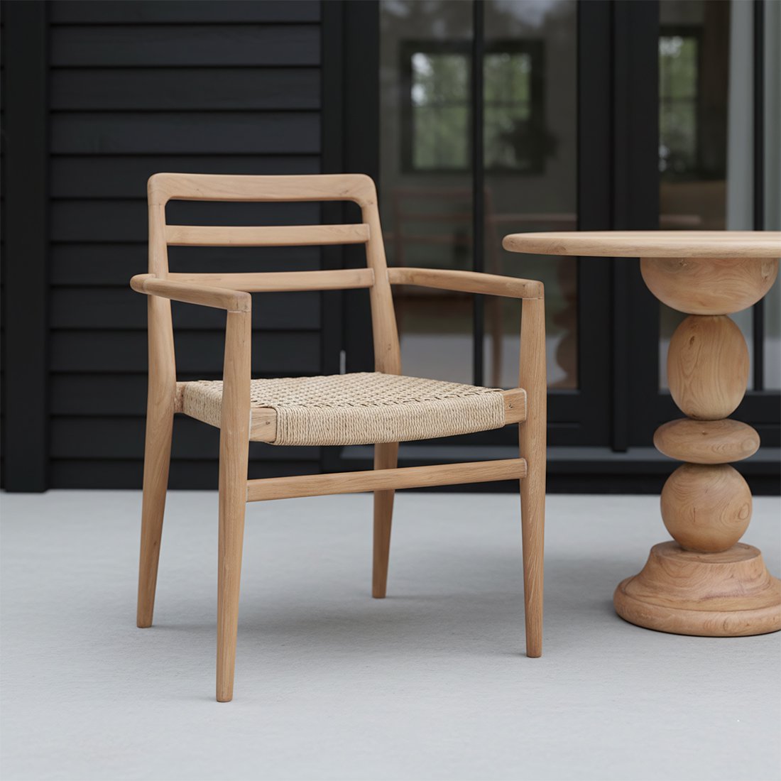 Tuinstoel teak in naturel Verano op een veranda naast een houten organische bijzettafel