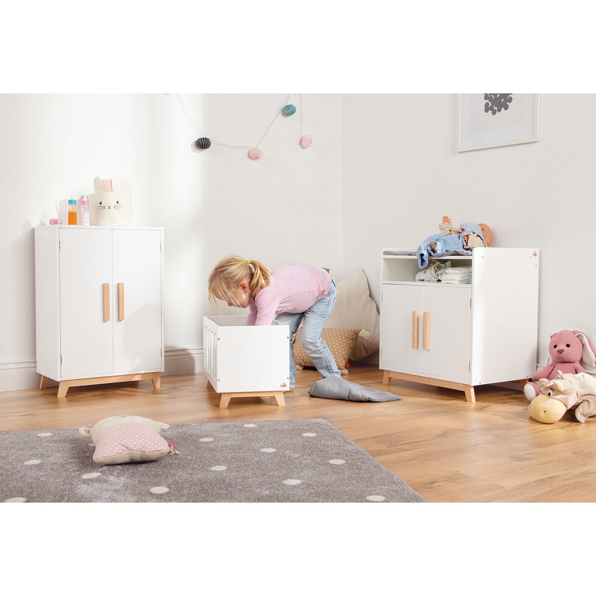 Wit poppenbed in een gezellige speelkamer. 